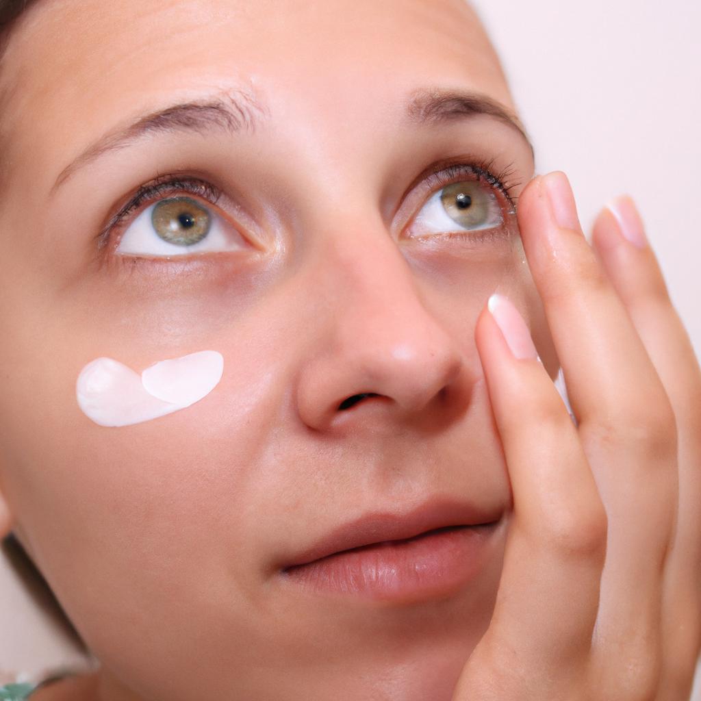 Person applying moisturizer on face